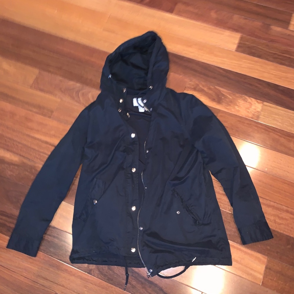 Black coat has like a rain resistant material